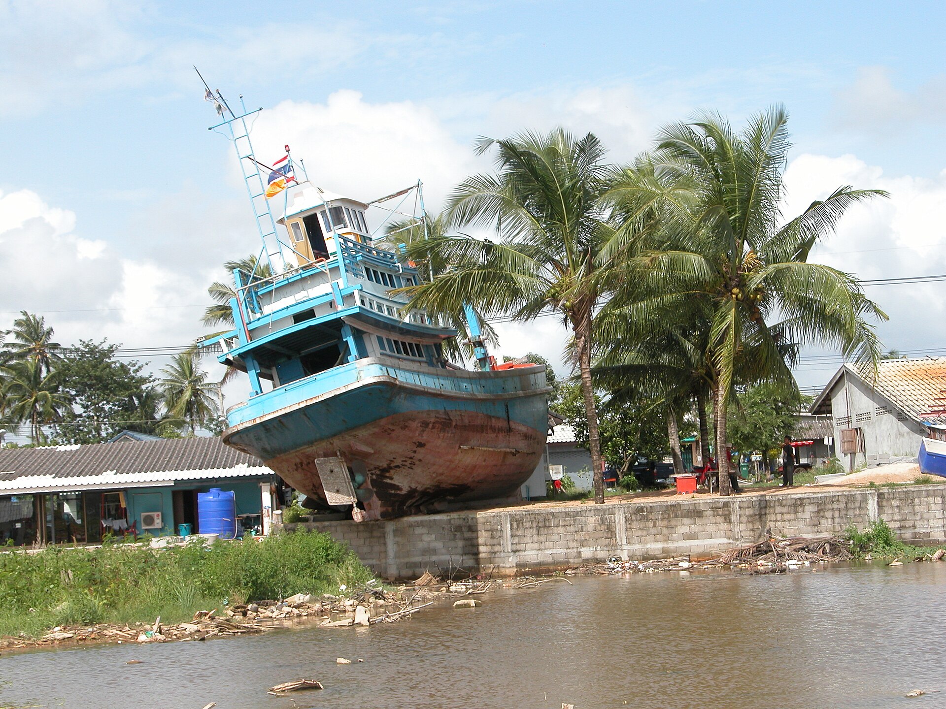 The Choksiriphon, a fishing boat swept ashore in the village of Ban Nam Khem, Phang-nga Province, Thailand. It has since been incorporated into the landscape of the Ban Nam Khem Tsunami Museum.