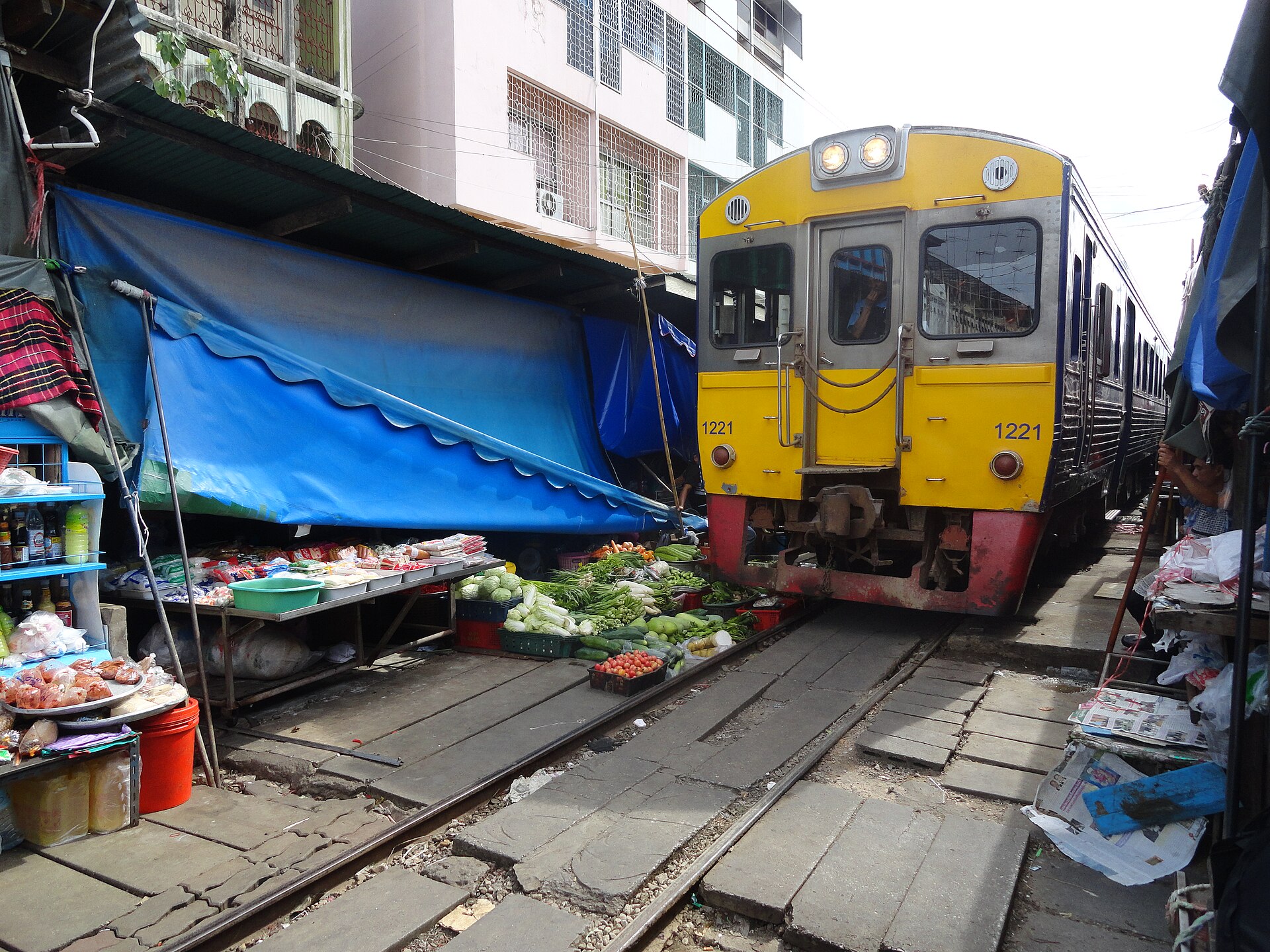 The train is coming! A shot taken at Maeklong Railway Market in Samut Songkhram, about 80 Km South-west of Bangkok.