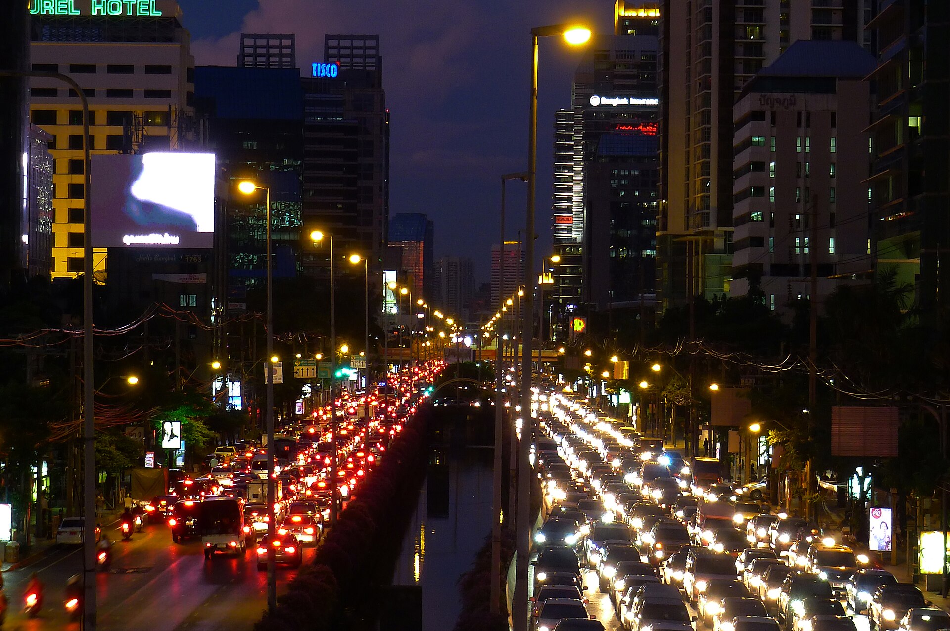Sathon Road in Bangkok at rush hour near the intersection with Naradhiwas Rajanagarindra Road.