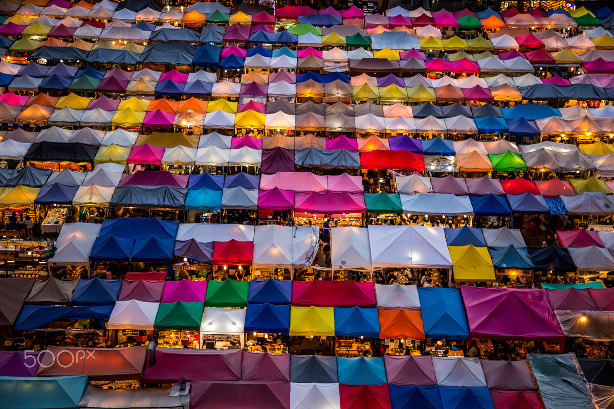 500px provided description: Rotfai Market [#city ,#color ,#street ,#travel ,#tourism ,#urban ,#architecture ,#cityscape ,#road ,#building ,#pattern ,#market ,#bangkok ,#sight ,#modern ,#high ,#outdoors ,#landmark ,#night market ,#bazaar ,#view from a