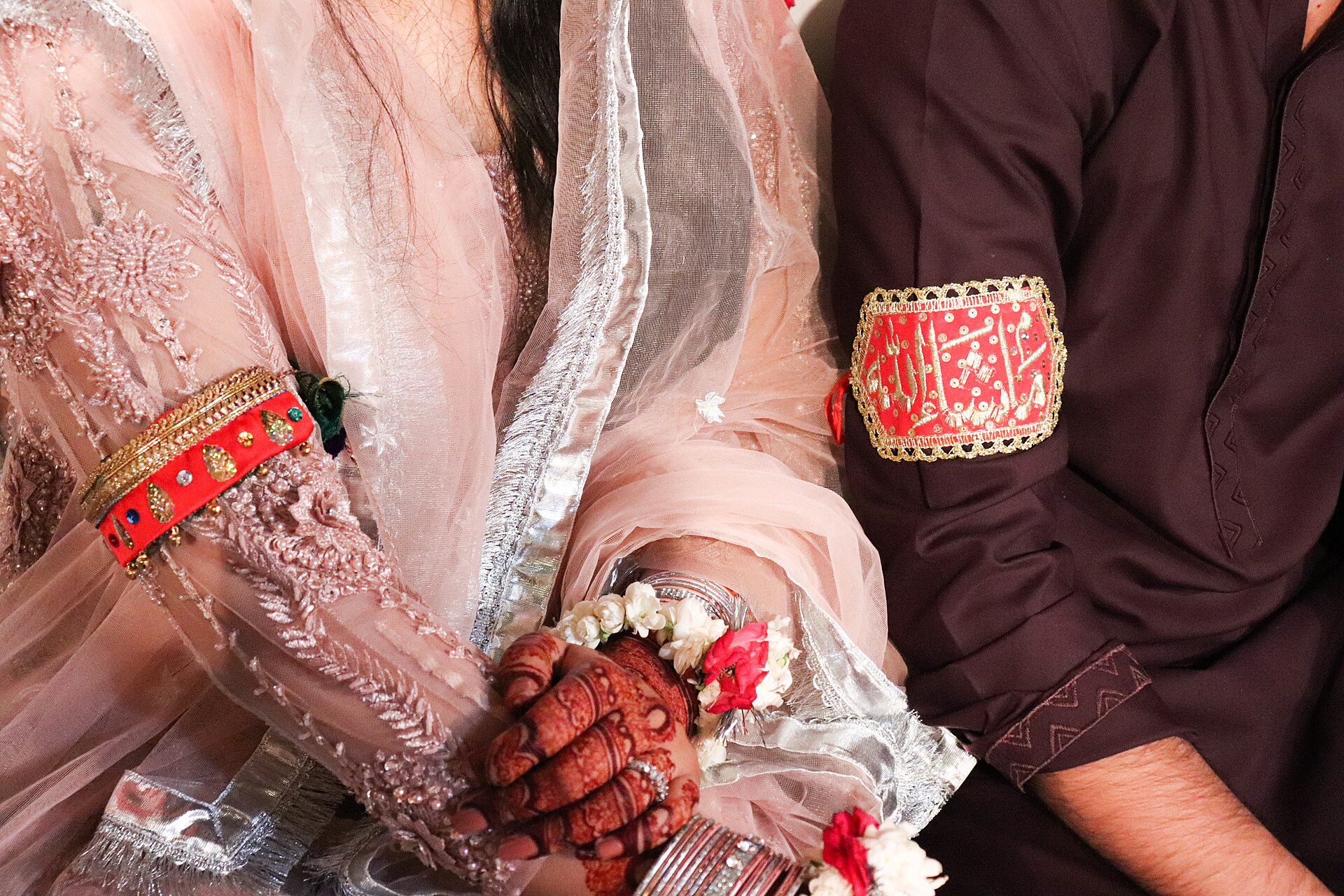Imam Zamin is a band that is tied up on the arms of bride and groom before their wedding, engagement. It is often tied up for safety when someone is travelling too. But mainly in weddings to protect the couple from evil. (Muslim community)
