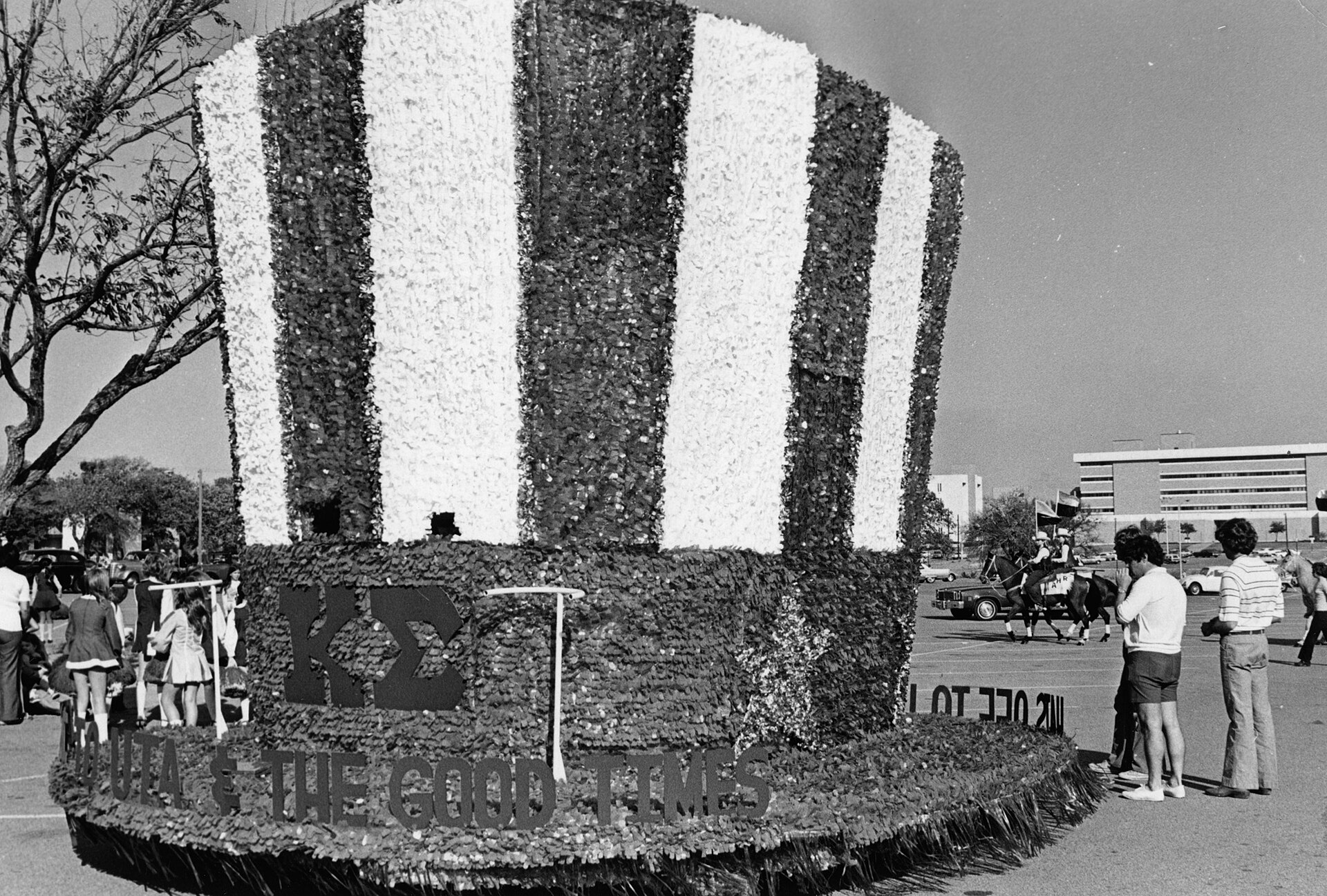 University of Texas at Arlington homecoming; top hat parade float with "Hats Off to UTA & the Good Times" on banner.