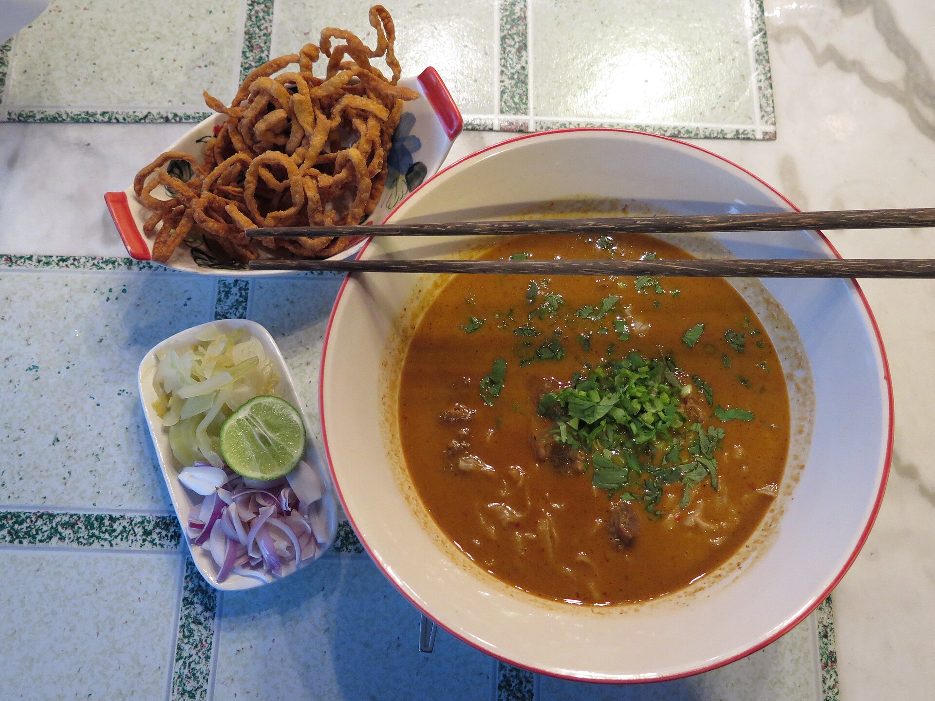 A bowl of khao soi, which is a spicy noodle soup commonly found in Chiang Mai. Chiang Mai, Thailand.
